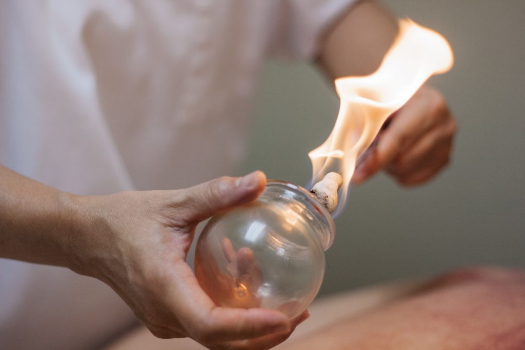 Traditionally, practitioners place a flammable substance, like alcohol, dried herbs, cotton, or wool, inside the cup.